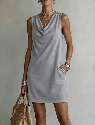 Women's grey sleeveless pocket mini dress with a draped neckline.