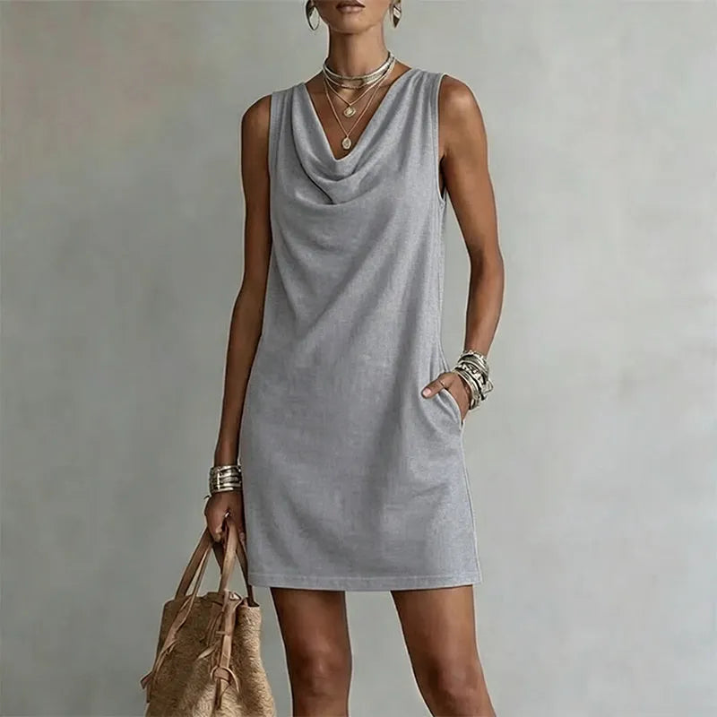 Women's grey sleeveless pocket mini dress with a draped neckline.