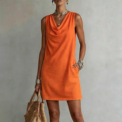 Women's orange sleeveless pocket mini dress with a draped neckline.