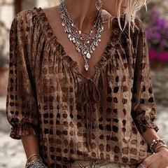 Women's relaxed brown polka dot blouse with a lace-up V-neck and three-quarter puff sleeves