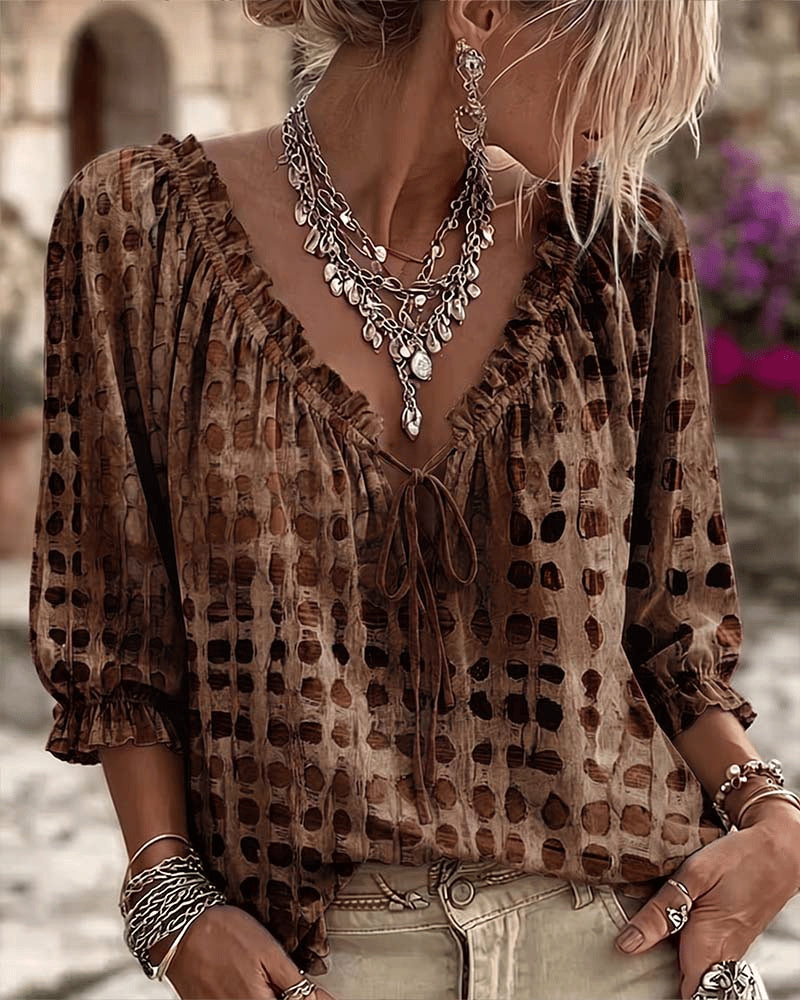 Women's relaxed brown polka dot blouse with a lace-up V-neck and three-quarter puff sleeves