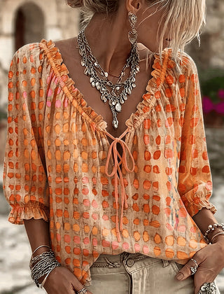 Women's relaxed orange polka dot blouse with a lace-up V-neck and three-quarter puff sleeves