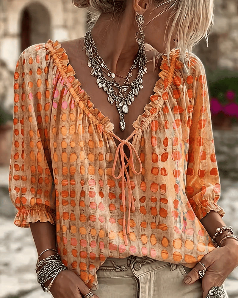Women's relaxed orange polka dot blouse with a lace-up V-neck and three-quarter puff sleeves