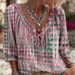Women's relaxed pink polka dot blouse with a lace-up V-neck and three-quarter puff sleeves