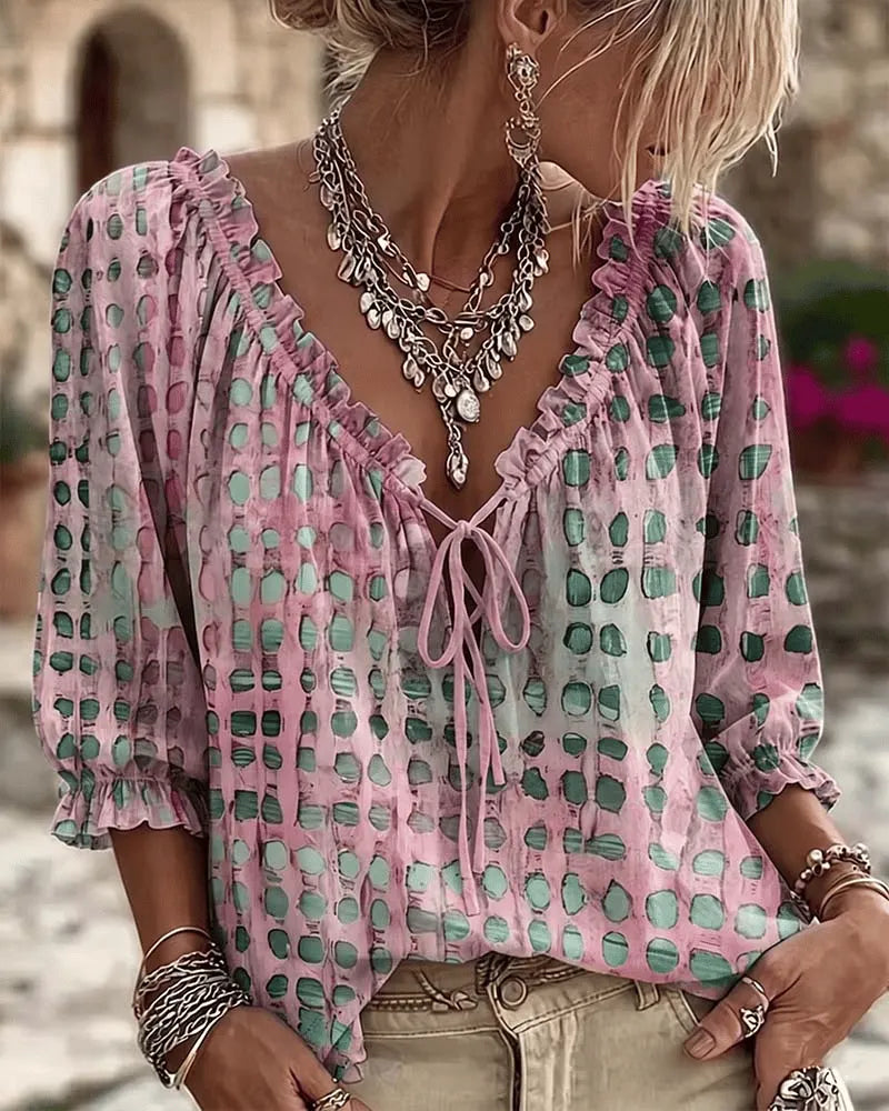Women's relaxed pink polka dot blouse with a lace-up V-neck and three-quarter puff sleeves