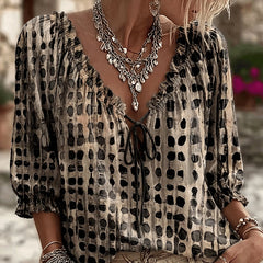 Women's relaxed black polka dot blouse with a lace-up V-neck and three-quarter puff sleeves