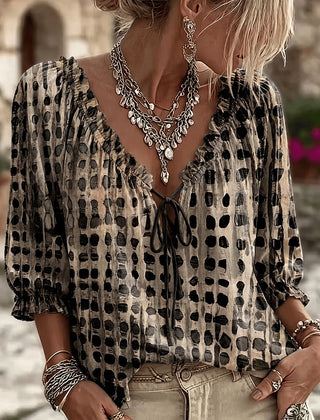 Women's relaxed black polka dot blouse with a lace-up V-neck and three-quarter puff sleeves