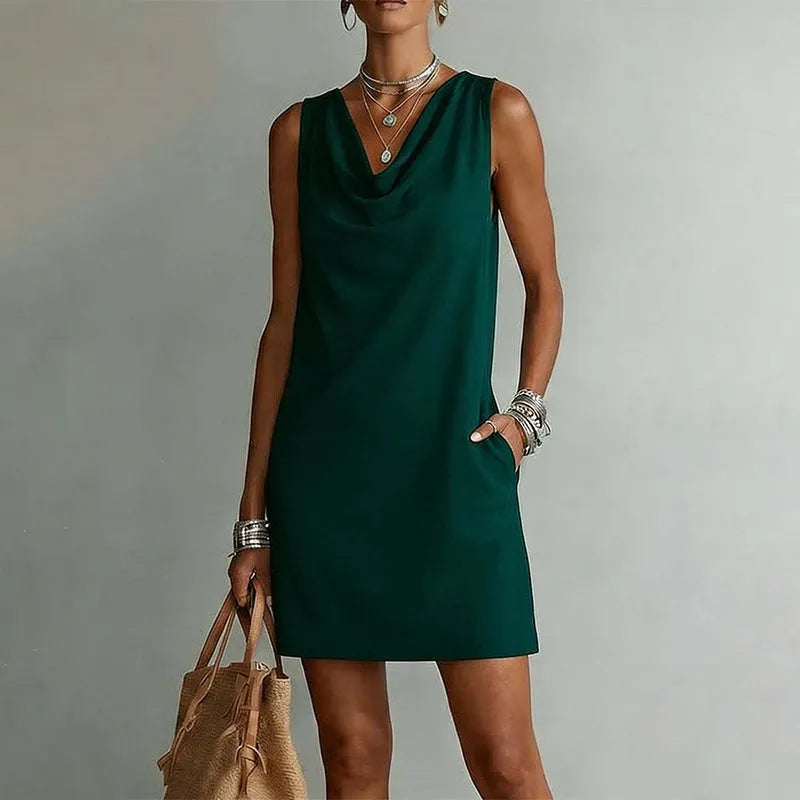Women's green sleeveless pocket mini dress with a draped neckline.