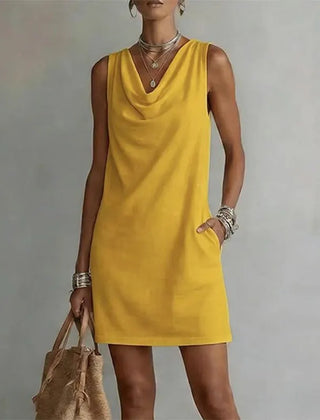Women's yellow sleeveless pocket mini dress with a draped neckline.