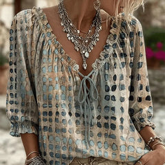 Women's relaxed blue polka dot blouse with a lace-up V-neck and three-quarter puff sleeves