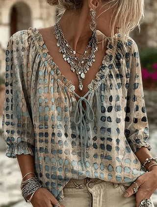 Women's relaxed blue polka dot blouse with a lace-up V-neck and three-quarter puff sleeves