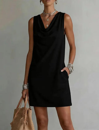 Women's black sleeveless pocket mini dress with a draped neckline.