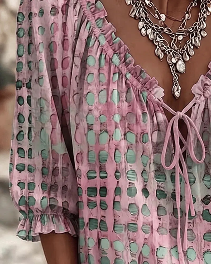 Close-up of the lace-up V-neck and polka dot print on the Araminta blouse