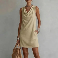 Women's khaki sleeveless pocket mini dress with a draped neckline.
