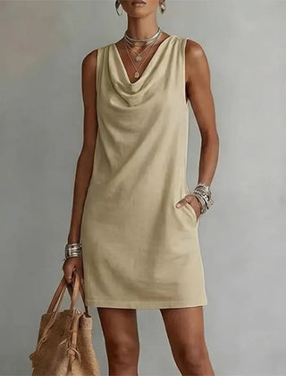 Women's khaki sleeveless pocket mini dress with a draped neckline.