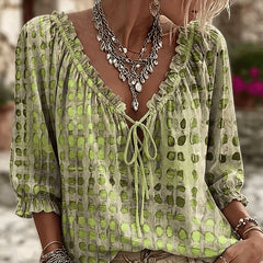 Women's relaxed green polka dot blouse with a lace-up V-neck and three-quarter puff sleeves