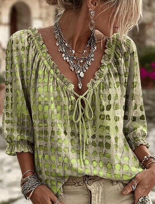 Women's relaxed green polka dot blouse with a lace-up V-neck and three-quarter puff sleeves