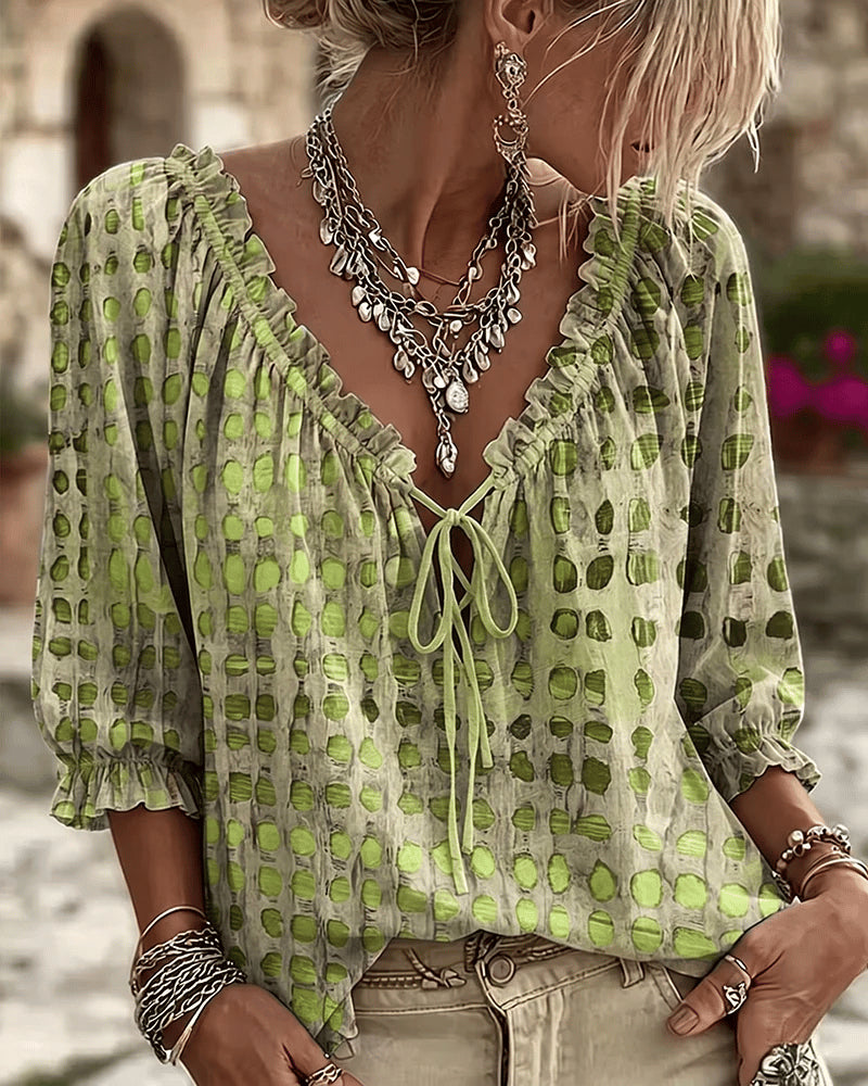 Women's relaxed green polka dot blouse with a lace-up V-neck and three-quarter puff sleeves