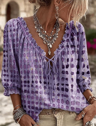 Women's relaxed purple polka dot blouse with a lace-up V-neck and three-quarter puff sleeves