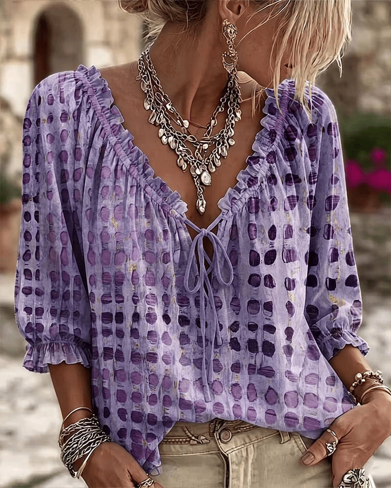 Women's relaxed purple polka dot blouse with a lace-up V-neck and three-quarter puff sleeves