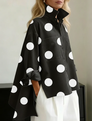 Women's black polka dot button-up shirt with spread collar and chest pockets.