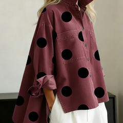 Women's red polka dot button-up shirt with spread collar and chest pockets.