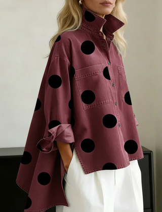 Women's red polka dot button-up shirt with spread collar and chest pockets.