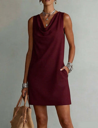 Women's red sleeveless pocket mini dress with a draped neckline.