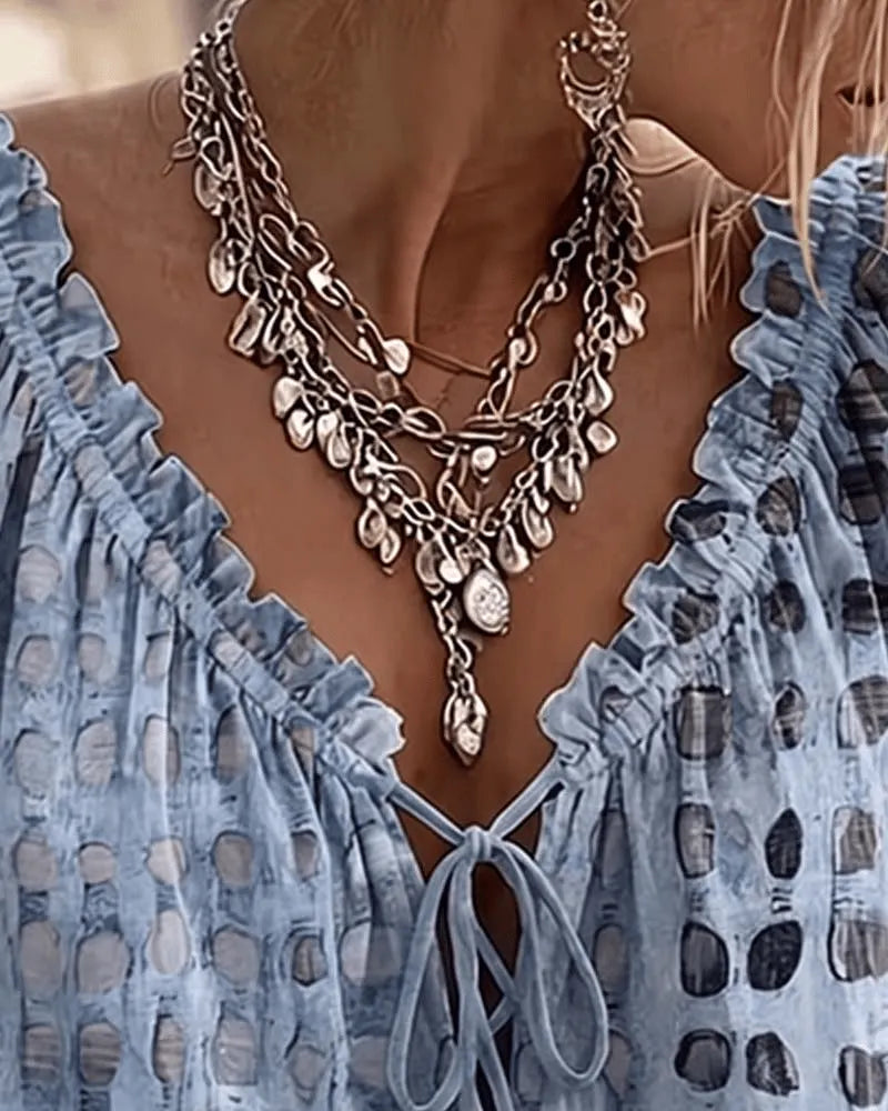 Woman wearing the Araminta relaxed blouse with gently puffed three-quarter sleeves