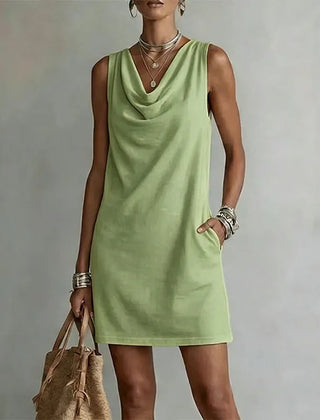 Women's matcha green sleeveless pocket mini dress with a draped neckline.