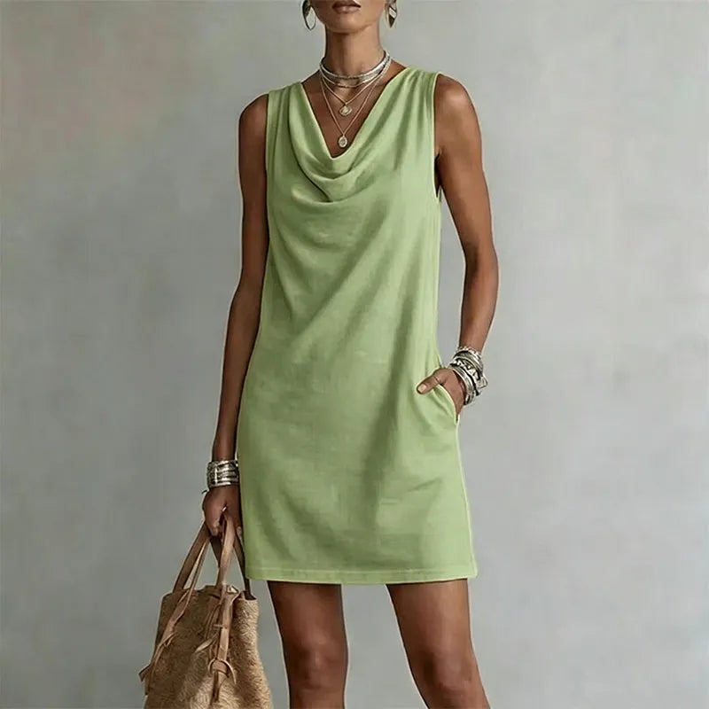 Women's matcha green sleeveless pocket mini dress with a draped neckline.