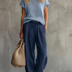 Woman wearing red comfortable knit pullover top with matching wide-leg trousers