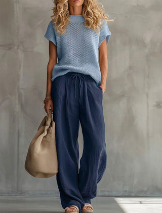 Woman wearing red comfortable knit pullover top with matching wide-leg trousers