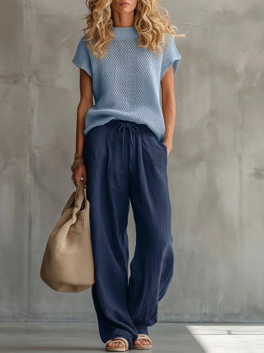 Woman wearing red comfortable knit pullover top with matching wide-leg trousers