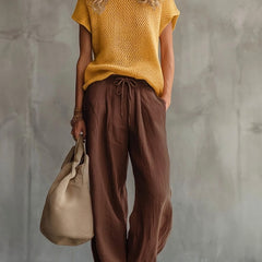 Close-up of the red knitted pullover top texture and crew neckline